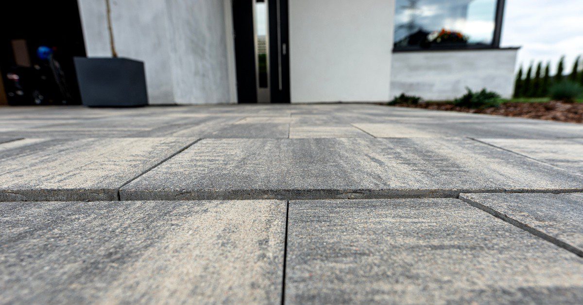 Sunken paving slabs on residential driveway showing subsidence Residential concrete driveway